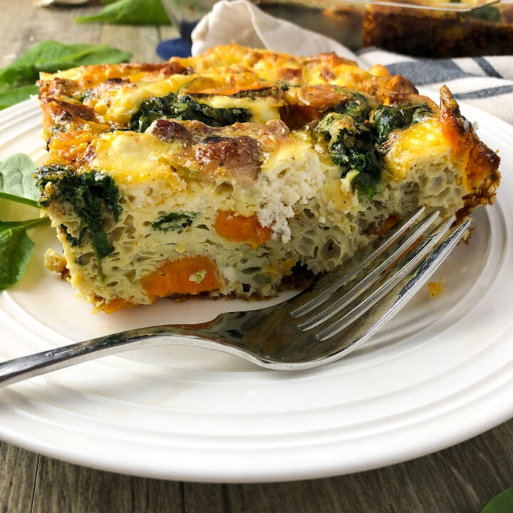 a piece of high protein breakfast casserole on a plate with a fork